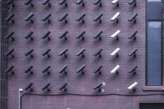 A picture of a masked man walking around cameras