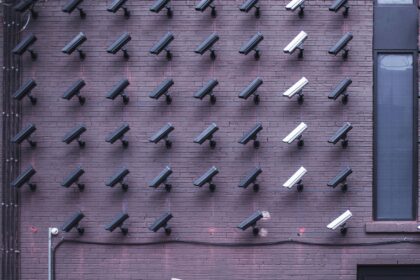 A picture of a masked man walking around cameras