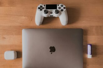A picture of a laptop and a playstation 4 controller