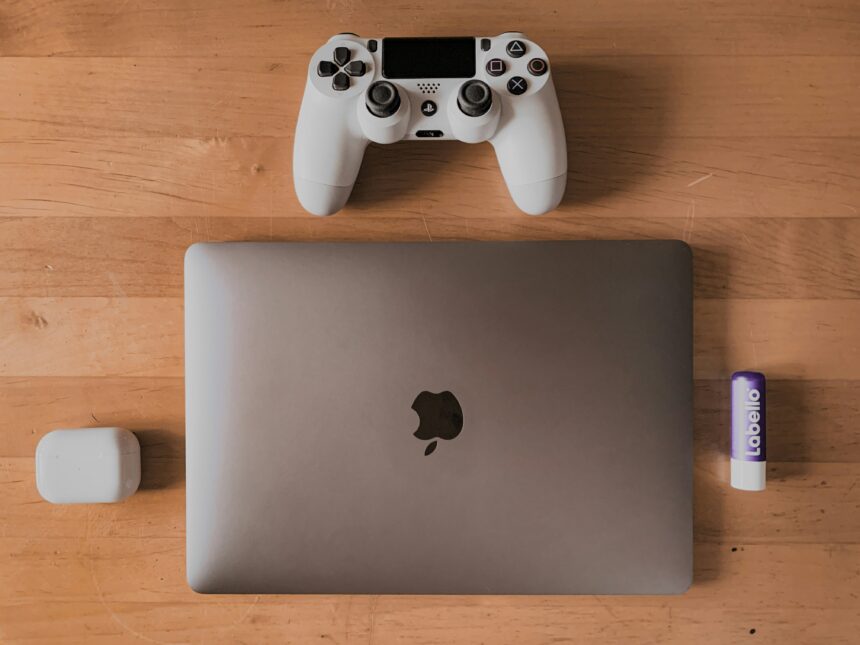 A picture of a laptop and a playstation 4 controller