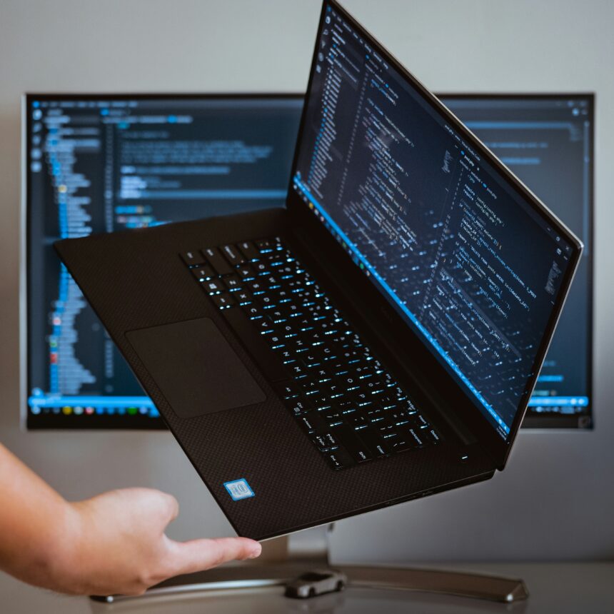A picture of a laptop on a finger